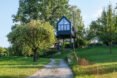 black treehouse with many windows