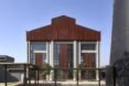 warehouse with several windows and weathered steel cladding