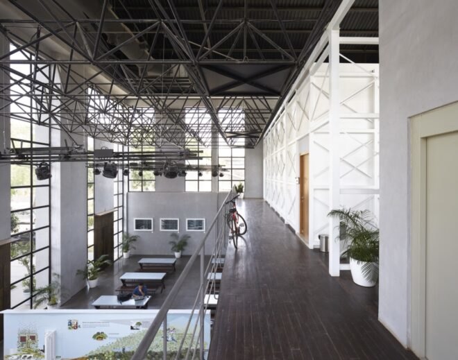 aerial view of warehouse interior with study tables and plants