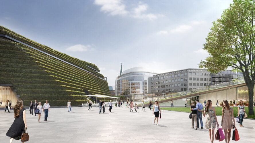 trapezoid-shaped building with sloping green roof in the summer