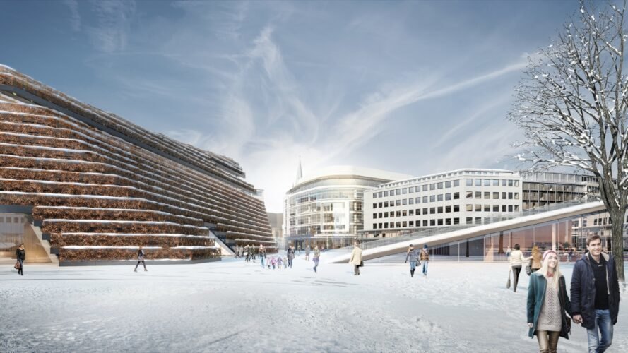 trapezoid-shaped building with sloping green roof covered in snow in the winter
