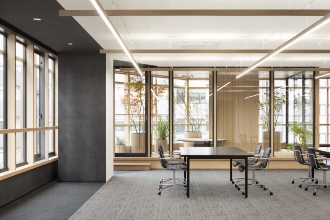 desk and chairs near glass-enclosed meeting room