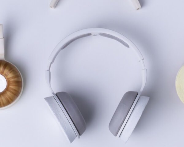 white and gray headphones next to headphone pieces