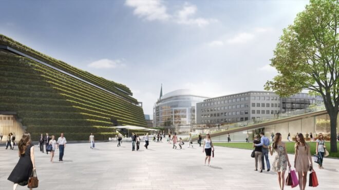trapezoid-shaped building with sloping green roof in the summer