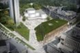 aerial view of trapezoid-shaped building with sloping green roof during the day