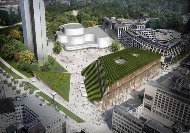 aerial view of trapezoid-shaped building with sloping green roof during the day