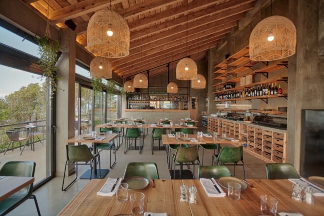 dining area with wood tables and glass walls