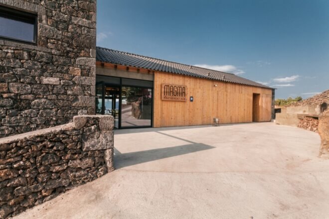 wood building with sign that reads "MAGMA"