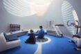 people playing video games in small round room
