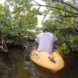 man kayaking in lagoon