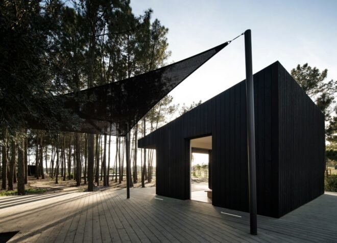 black solar shade beside a black cabin