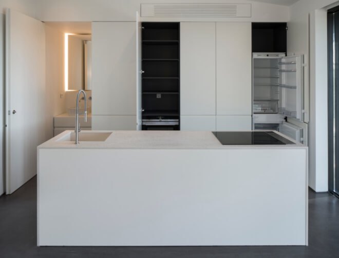 white contemporary kitchen with cabinets opened up