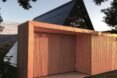 wood slats in front of dark A-frame home