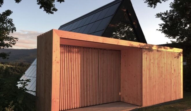 wood slats in front of dark A-frame home