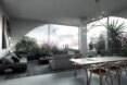 open-plan space with huge windows showing views of plants and the city
