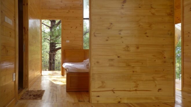 wood-lined interior with small plush bed