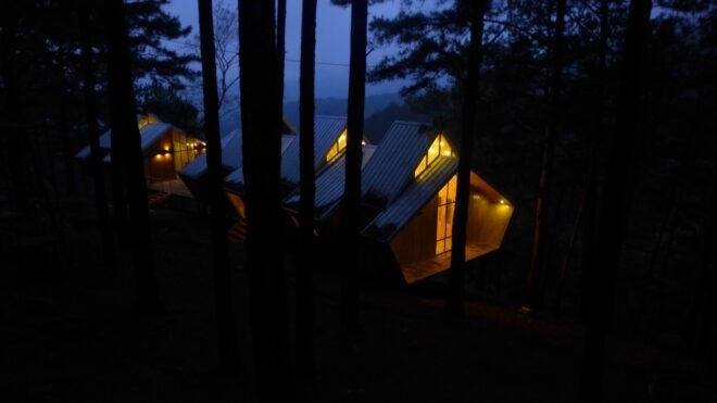 wood cabins lit up at night