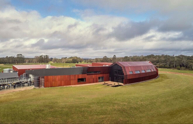 elongated red metal building with reflective facade