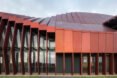 long building with red metal cladding