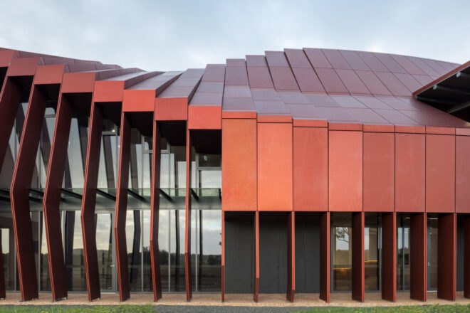 long building with red metal cladding