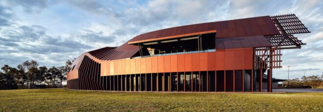 elongated modern building with reflective facade
