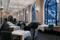 dining room of the hotel with large windows with snow covered mountain views