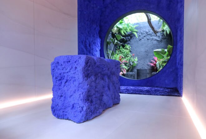 blue stone in front of blue wall with cutout
