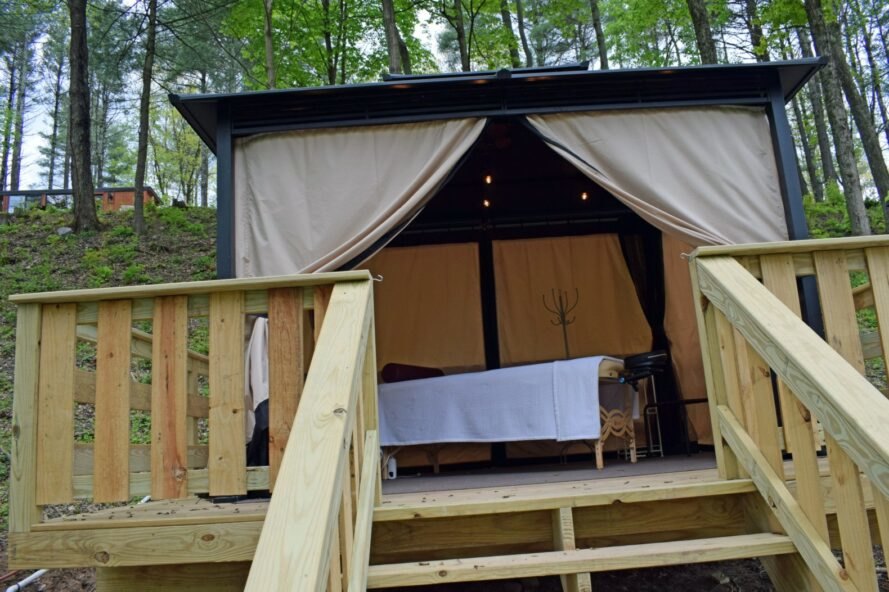 a single bed on a wooden deck