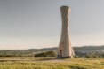 twisted wood tower on hilly landscape