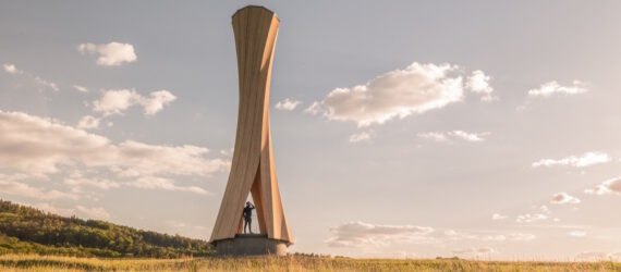 twisted wood tower on hilly landscape