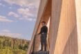 person standing on balcony of twisted wood structure