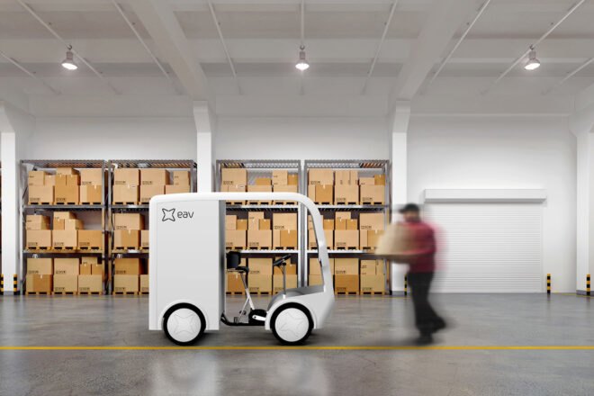small white electric cargo quadricycle at a warehouse