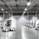 small white electric cargo quadricycle at a warehouse
