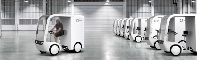 small white electric cargo quadricycle at a warehouse