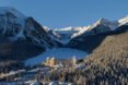 hotel is nestled in between mountains and forest covered in snow