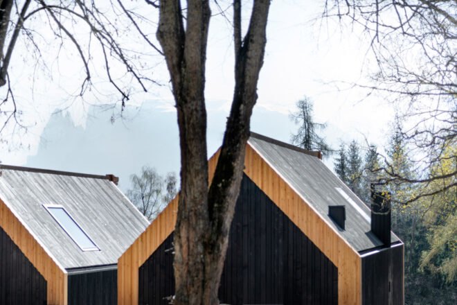 black wood cabins overlooking mountain and forest views