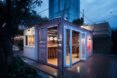 small gray shipping container with doors and windows open