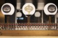 beer glasses lined up on a counter