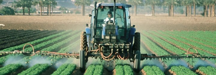 farmer sprays pesticide on agricultural fields