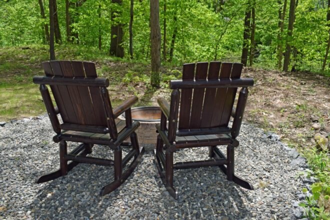 two adirondack chairs around a firepit