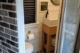 door open to bathroom with shiplap walls