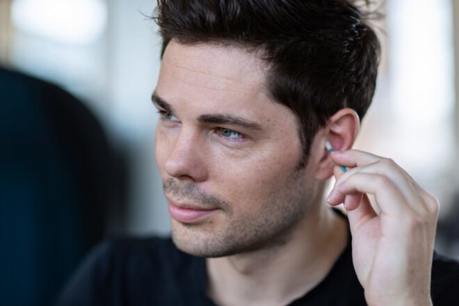 man cleaning ear with reusable swab
