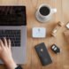 small white box of cutlery beside coffee mug and laptop