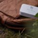 small white box of cutlery on brown backpack