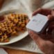 person opening small white box with cutlery inside