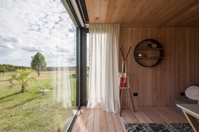 wood-lined interior with large glass window
