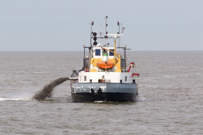 boat out at sea dredges for sand