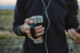 man holding steel mug