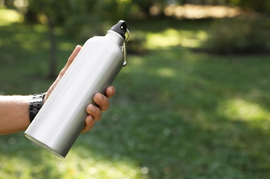 hand holding a steel water bottle