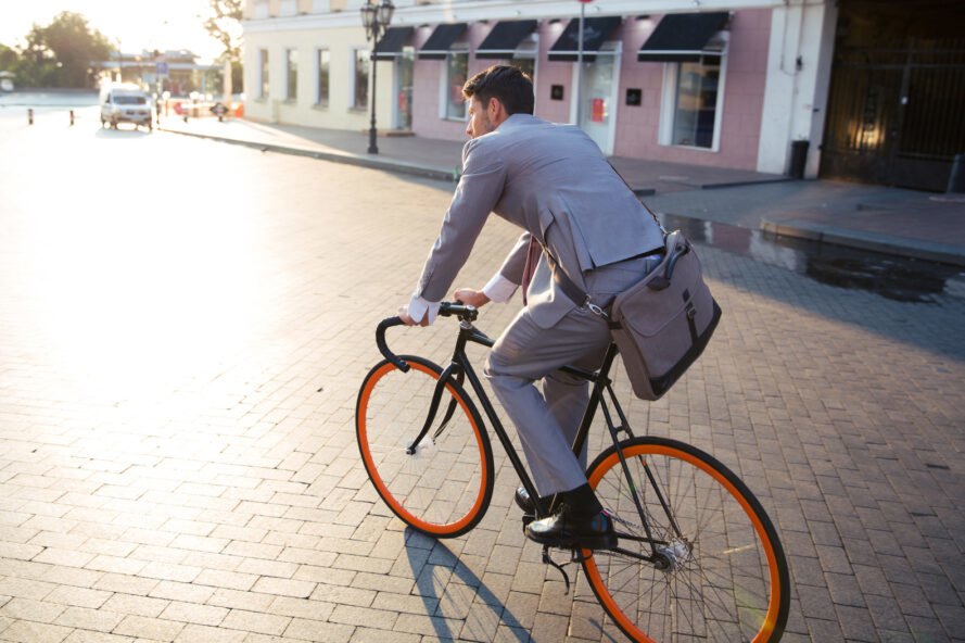 man dressed in suit biking to work